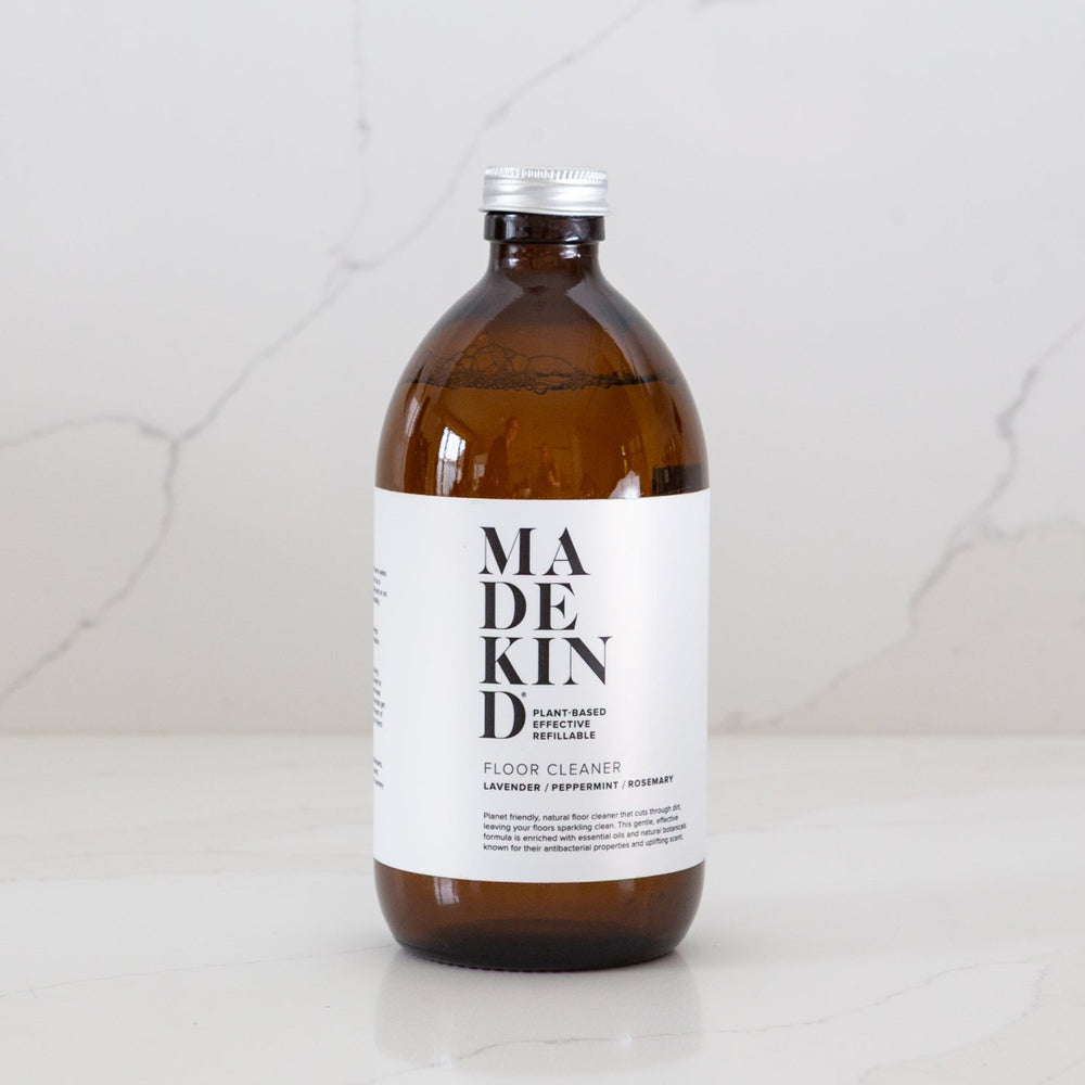 Photo of MadeKind Floor Cleaner in an amber glass bottle