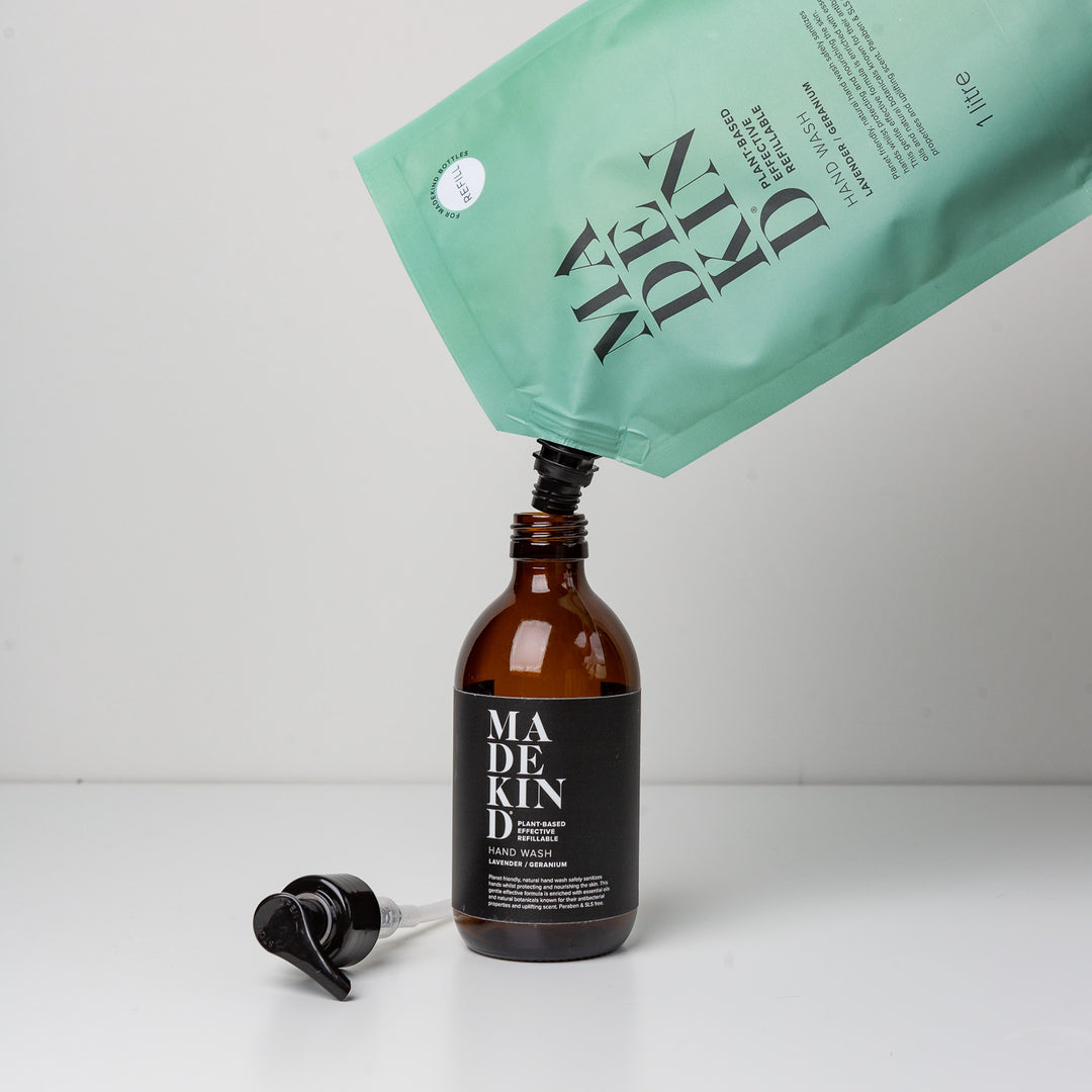 Photo of a 1 litre refill pouch refilling an empty hand wash bottle