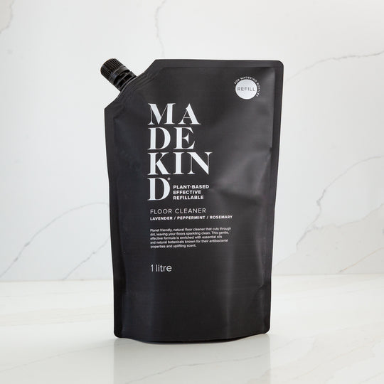 refillable container for natural floor cleaner with 'Made Kind' branding on a white background