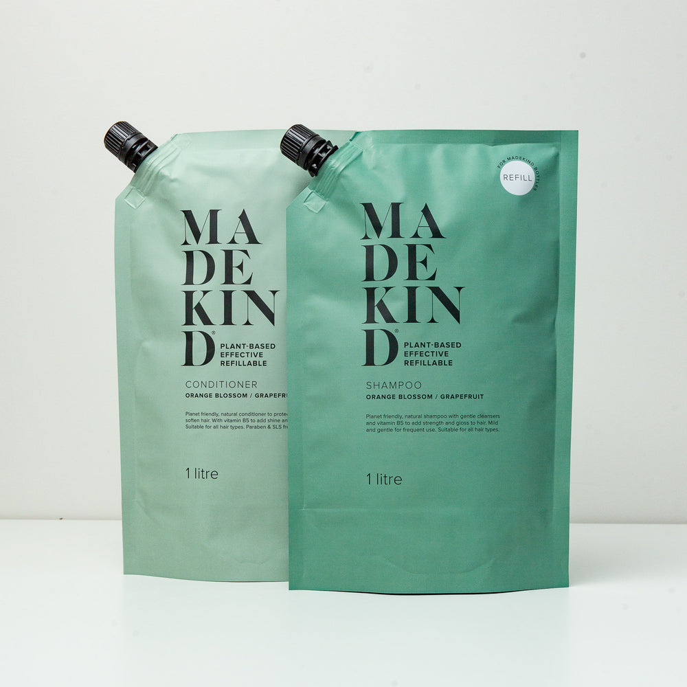 A photo of 1 Litre Refill pouches of MadeKind's natural shampoo and conditioner scented with orange blossom and grapefruit