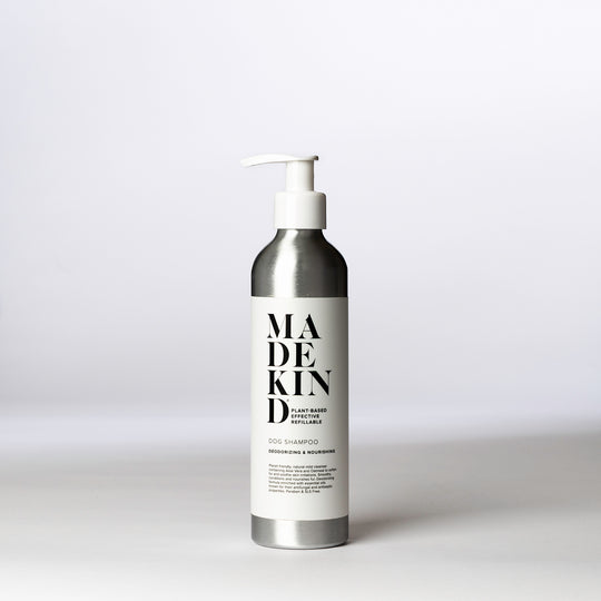 An aluminium bottle of MadeKind Dog Shampoo on a white surface