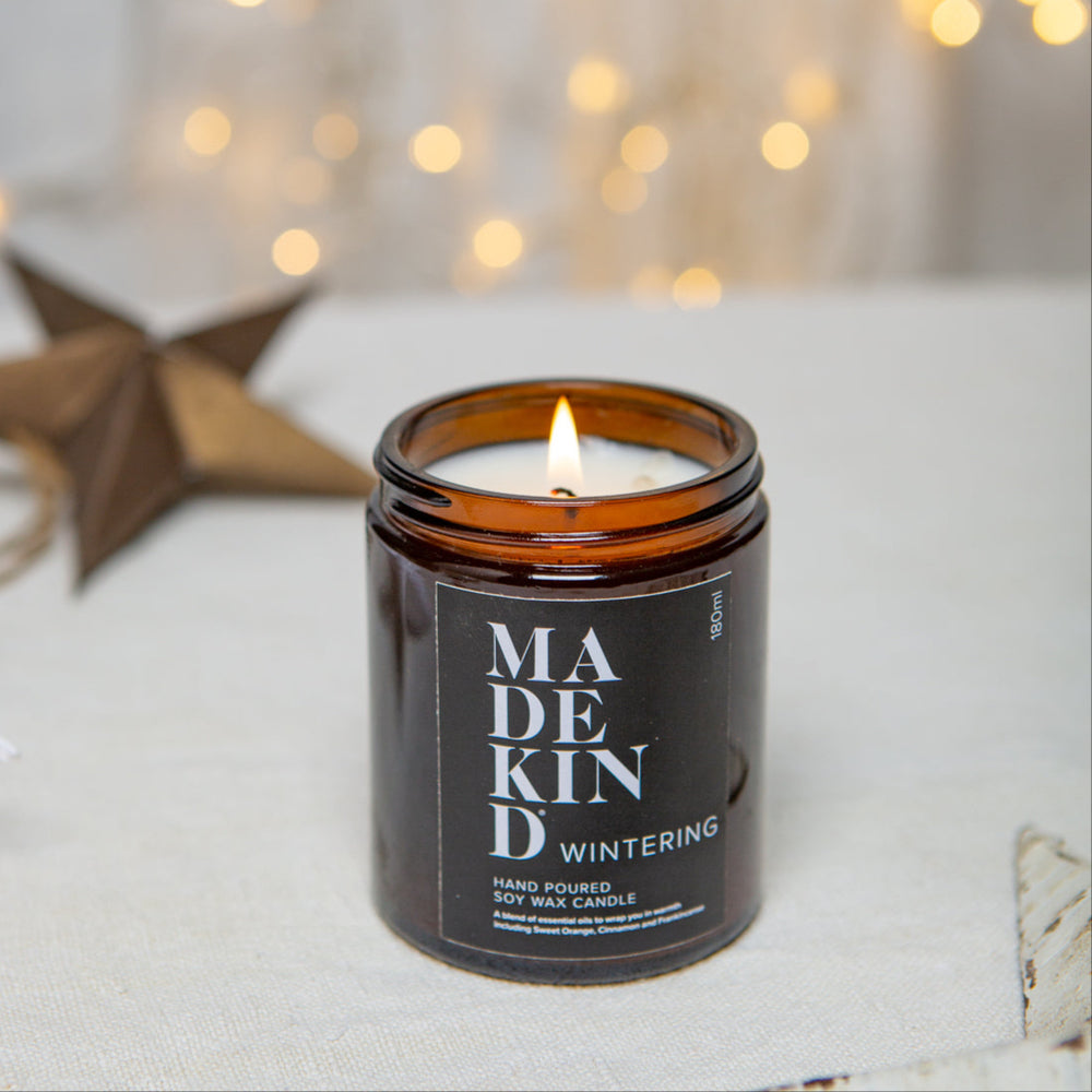 photo of a MadeKind 180ml Wintering soy wax aromatherapy candle with a christmas star in the background