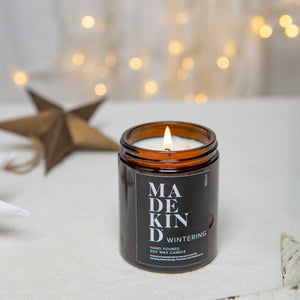 photo of a MadeKind 180ml Wintering soy wax aromatherapy candle with a christmas star in the background