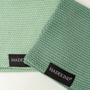 Photo of two green madekind organic cotton dishcloths 
