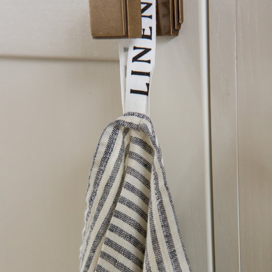 Photo of a Grey Striped Tea Towel hanging from a hook