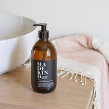 Load image into Gallery viewer, MadeKind natural hand wash 500ml in amber glass bottle in a modern bathroom by a sink
