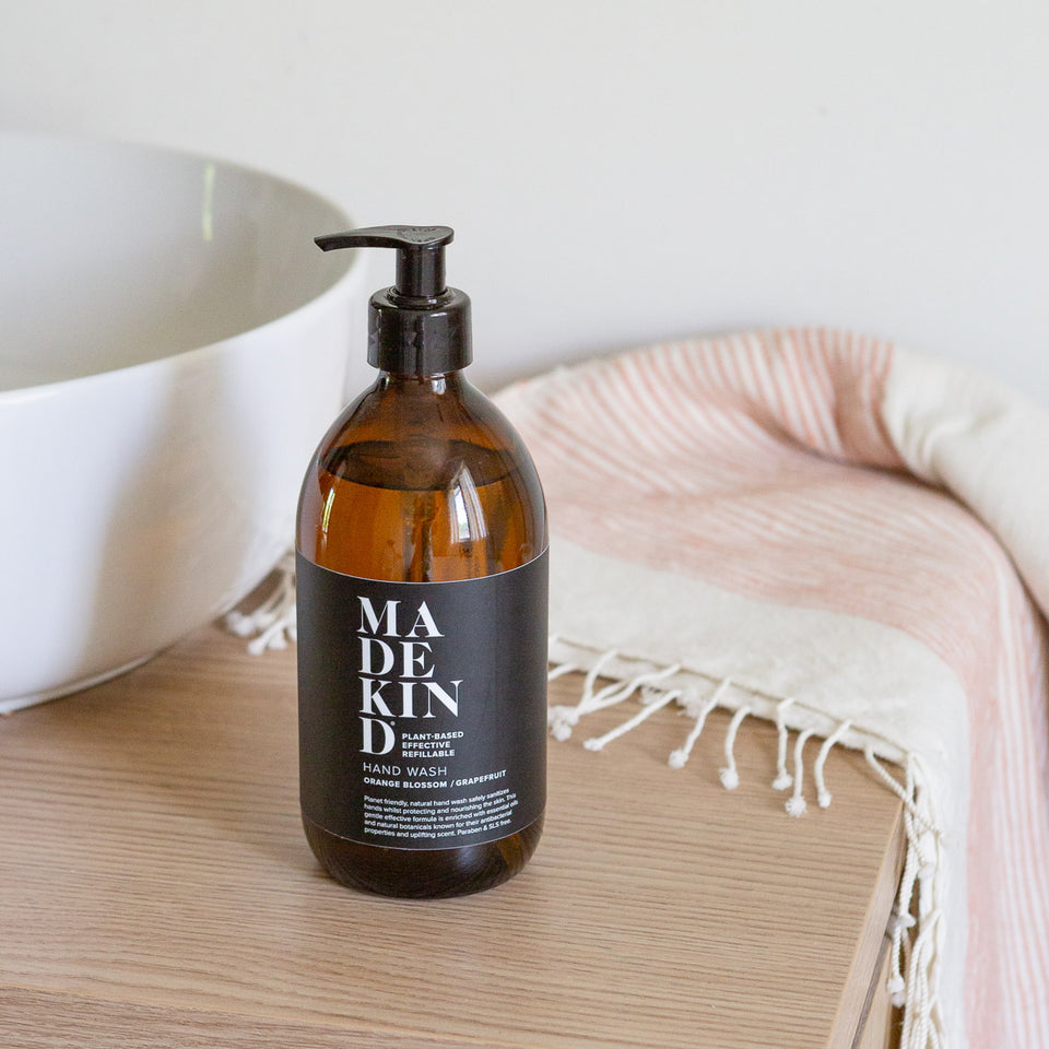 MadeKind natural hand wash 500ml in amber glass bottle in a modern bathroom by a sink