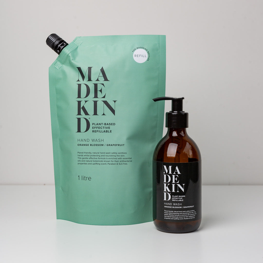 Photo of a 1 litre hand wash orange blossom & grapefruit with a MadeKind amber glass hand wash bottle