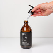 Load image into Gallery viewer, Photo of 300ml empty glass bottle for MadeKind hand wash with hand holding the pump
