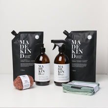 Load image into Gallery viewer, Photo of the MadeKind Kitchen Cleaning Kit; Multi Surface Cleaner and Dish Wash refills with 2 empty amber glass bottles, copper scourers and green dishcloths
