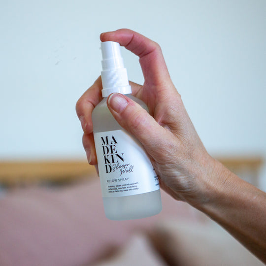 Photo of a hand holding a pillow spray