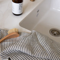 Photo of a striped tea towel next to a kitchen sink