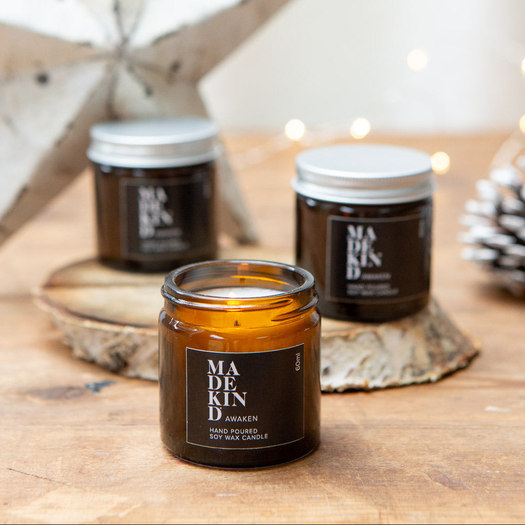 Madekind soy wax candle in small amber glass jar on table with Christmas decorations
