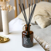 Load image into Gallery viewer, Aromatherapy reed diffuser with essential oils in amber glass jar on bedside table in bedroom
