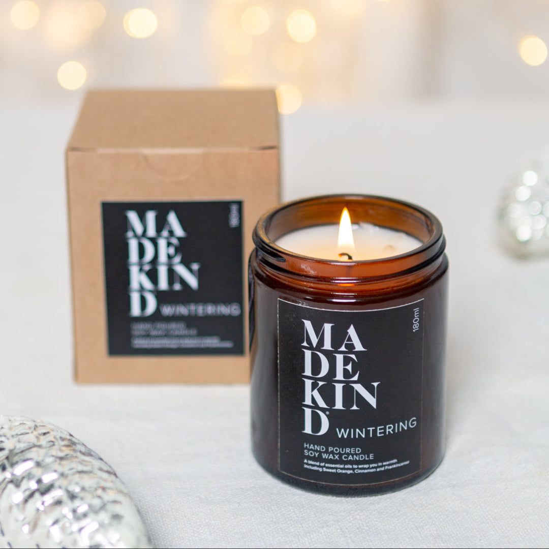 photo of a 180ml madekind wintering candle with gift box and christmas decorations