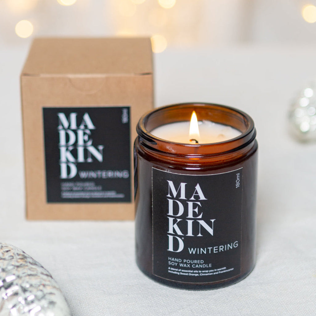 photo of a 180ml madekind wintering candle with gift box and christmas decorations