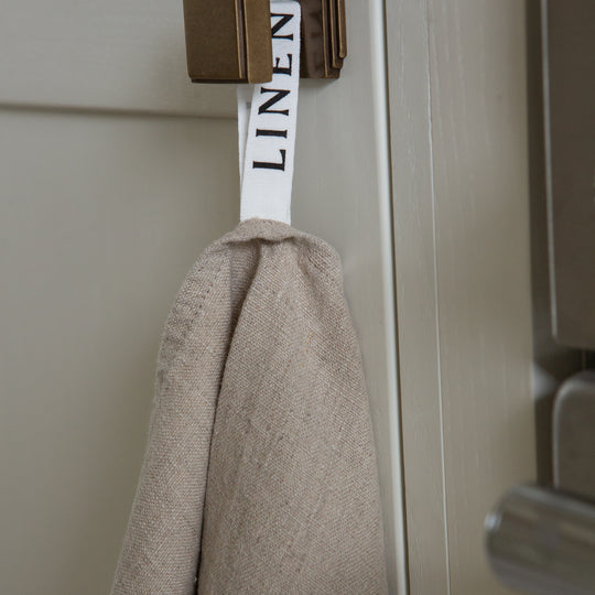 Photo of a tea towel hanging from a hook