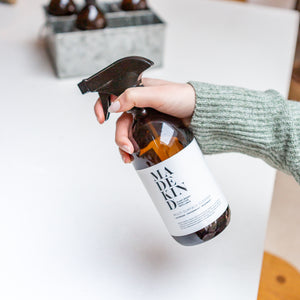 Photo of a MadeKind Natural, eco friendly multi surface cleaner in 500ml amber glass bottle being sprayed on a kitchen surface