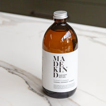 Load image into Gallery viewer, Photo of MadeKind Natural, eco friendly floor cleaner in 500ml amber glass bottle
