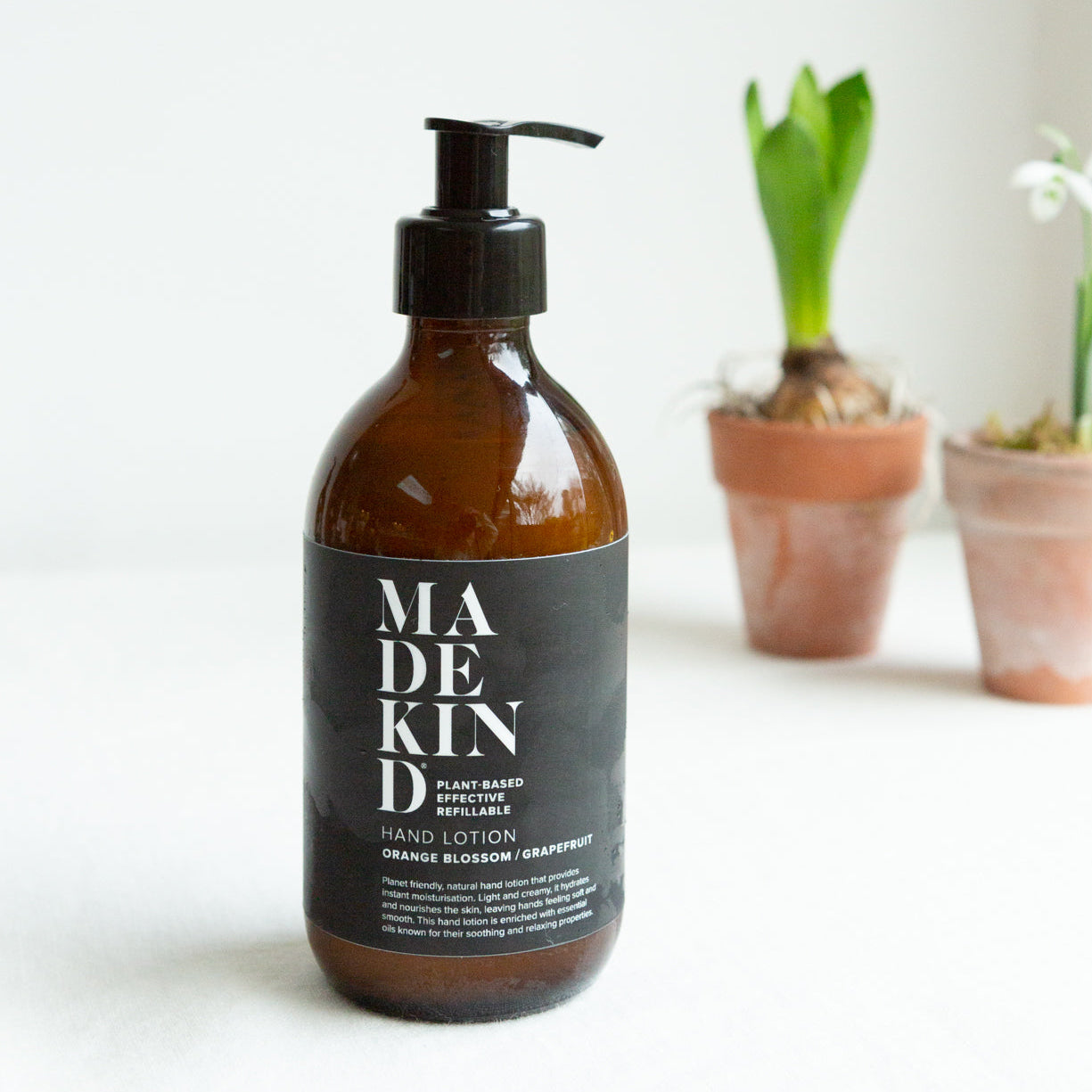Photo of MadeKind Natural hand lotion with orange blossom and grapefruit essential oils in a 300ml amber glass bottle
