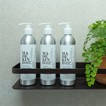 Load image into Gallery viewer, Photo of a wall bracket holding 3 MadeKind aluminium bottles, Body Wash, Shampoo and Conditioner
